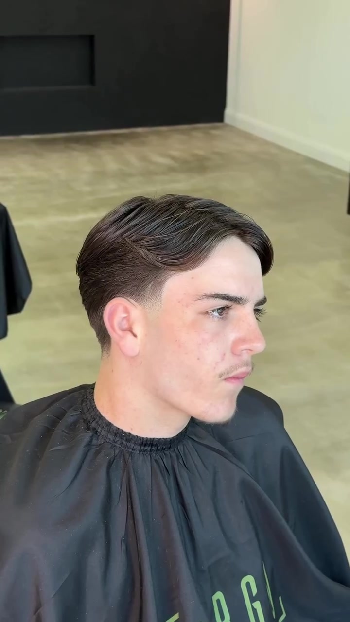 Side profile of a fresh skin fade with textured top