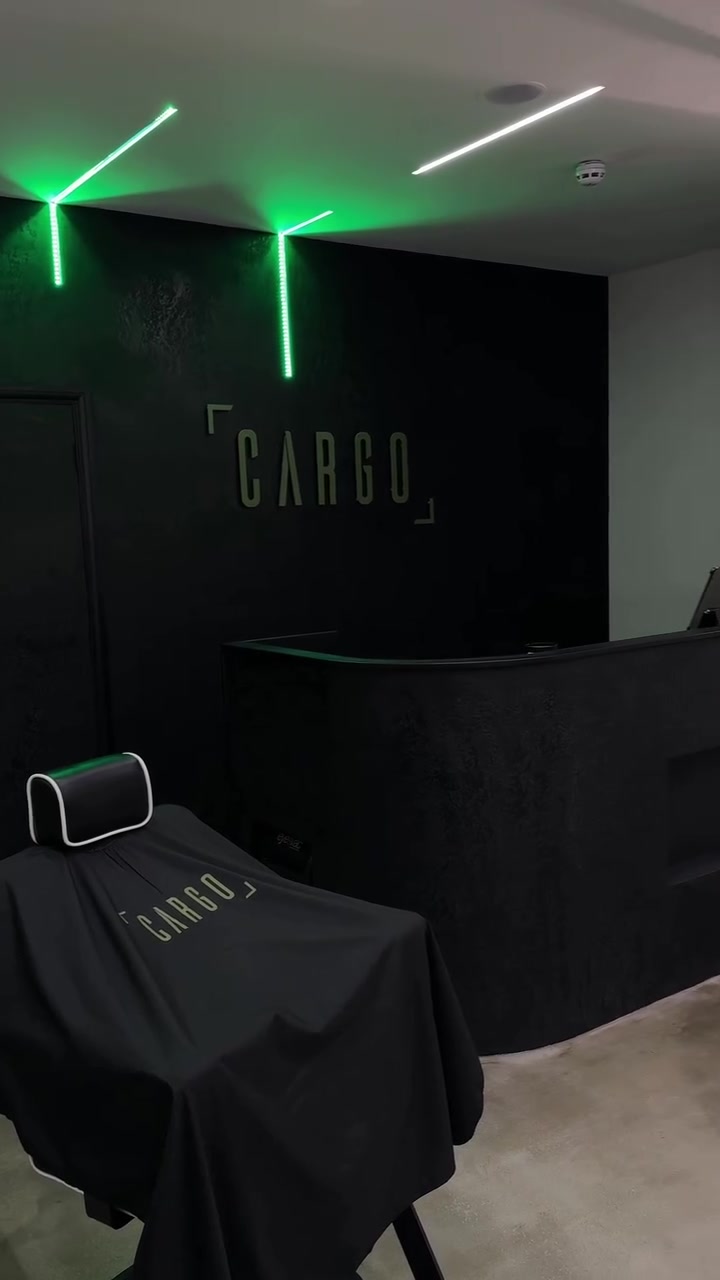 CARGO logo on the shop wall lit by green neon